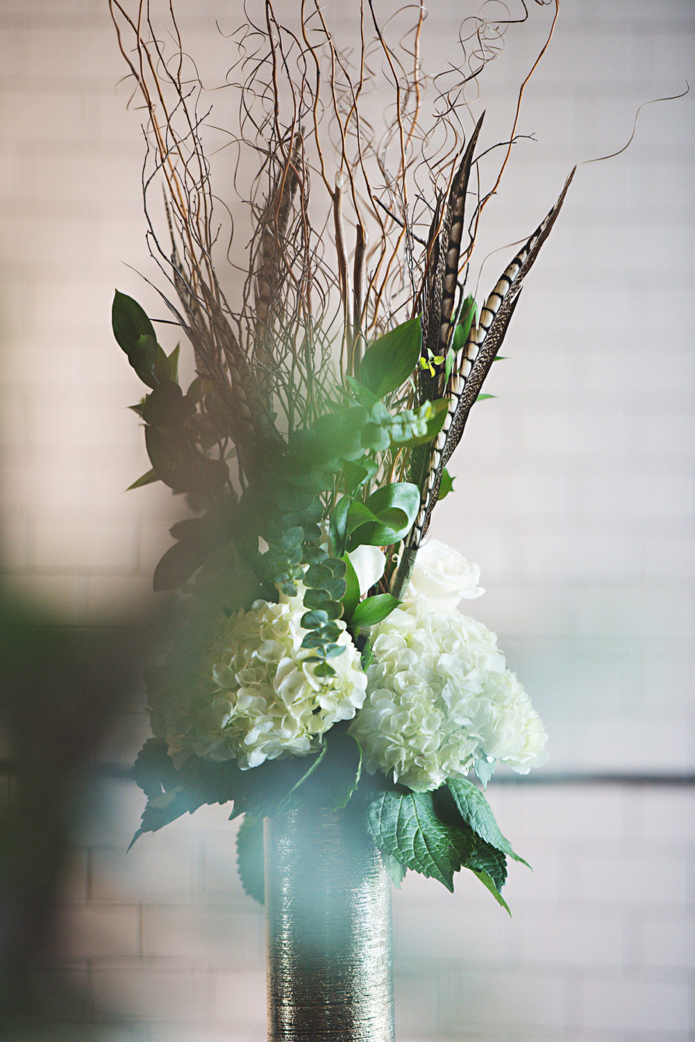 textured wedding centerpieces -wood, white, green, pheasant feathers